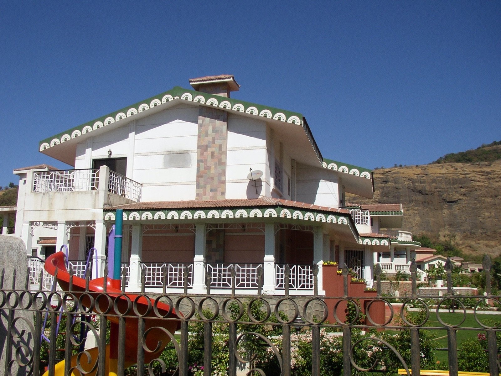 A Valley Queen Estates bungalow with scalloped eaves and a stone chimney